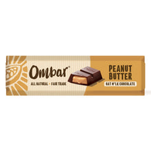 Ombar Peanut Butter Oat M’lk Chocolate wrapper in warm tan and cream, showing a chocolate square with peanut filling and a sunburst logo; artisanal feel.