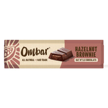 A chocolate-brown Ombar hazelnut brownie oat milk chocolate wrapper, with a chocolate piece pictured and “all natural, fair trade” text; warm, earthy tones.