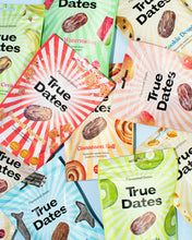 A colourful collage of True Dates snack packages in watermelon, cinnamon roll, caramel popcorn, and other flavors, with bold striped designs and playful appeal.