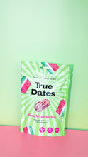 A green-and-white “True Dates” pouch labeled “Sour Watermelon,” with date fruit and watermelon graphics, against a mint-green and pink background. 