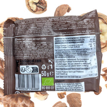 Back of a 50-gram Kookie Cat organic and vegan chocolate walnut cookie package, showing multilingual ingredients and nutrition facts, with cookies scattered on a white background.