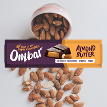 Ombar almond butter chocolate bar with almonds on a white background