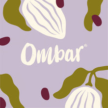 A pastel lavender Ombar chocolate wrapper features creamy white lettering and stylized cocoa pod shapes amid olive-green and burgundy accents, with a playful, elegant feel.