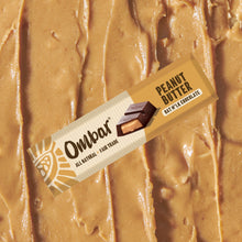 Ombar Peanut butter oat milk chocolate bar on peanut butter background