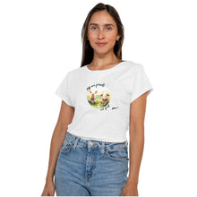 A woman wearing a white short sleeve graphic t-shirt with a circular print of two watercolour cute pigs in a field and the text 'Pigs are friends not food'.