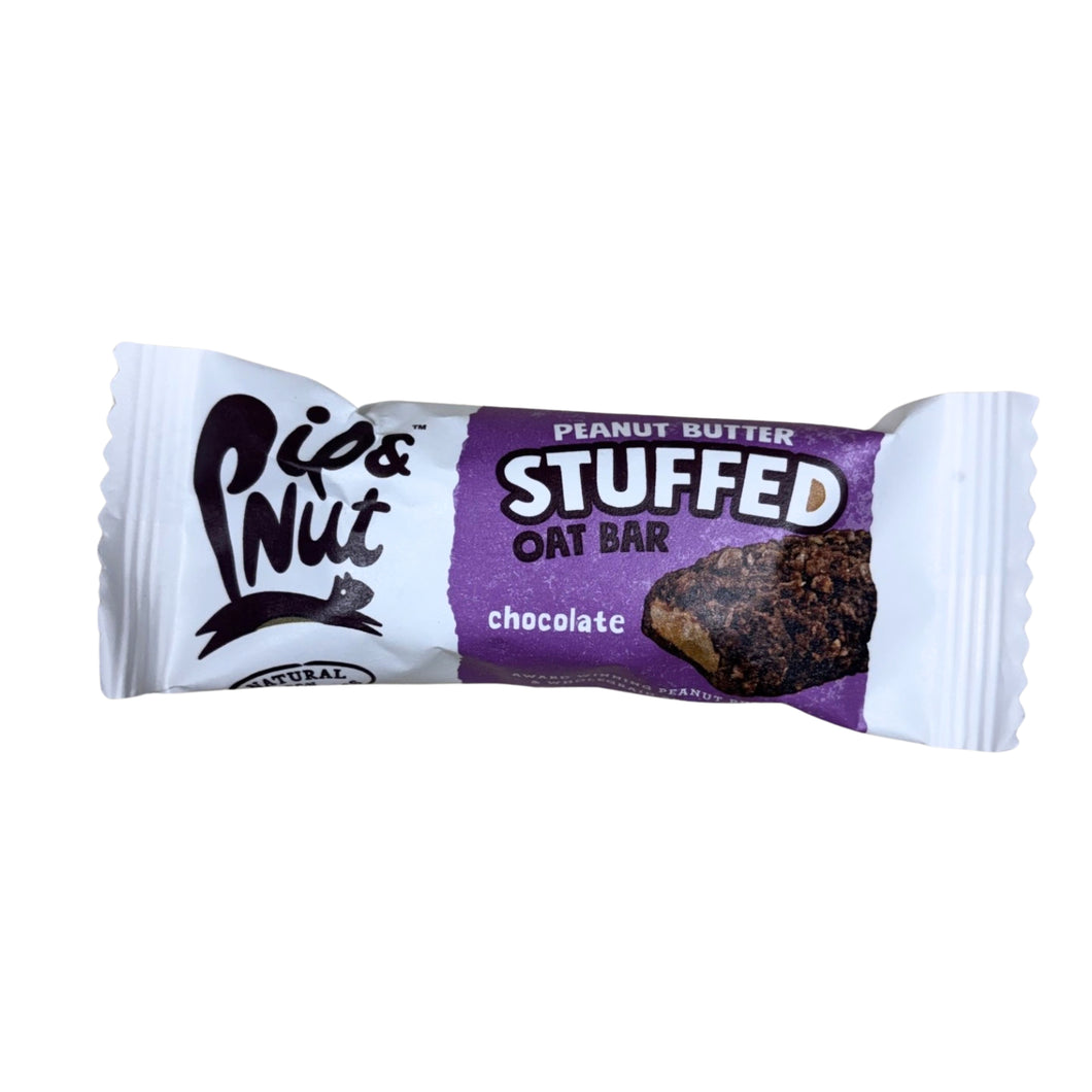 White-and-purple Pip & Nut wrapper for a chocolate peanut butter stuffed oat bar, pictured against a plain white background; bold, playful packaging.