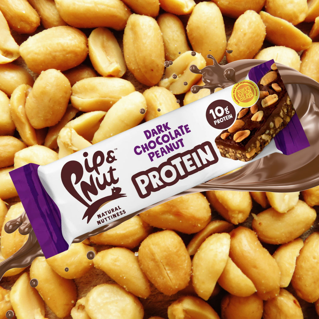 Pip & Nut Protein bar covered in Chocolate with peanuts in the background 