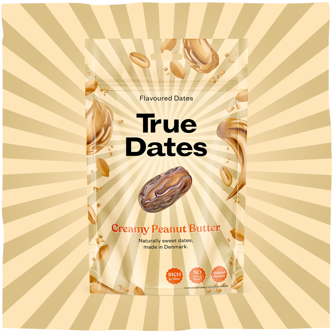 A beige-and-cream sunburst surrounds a clear pouch of True Dates, flavoured dates with creamy peanut butter. Floating dates and peanut butter swirls give the package a playful, appetizing look.