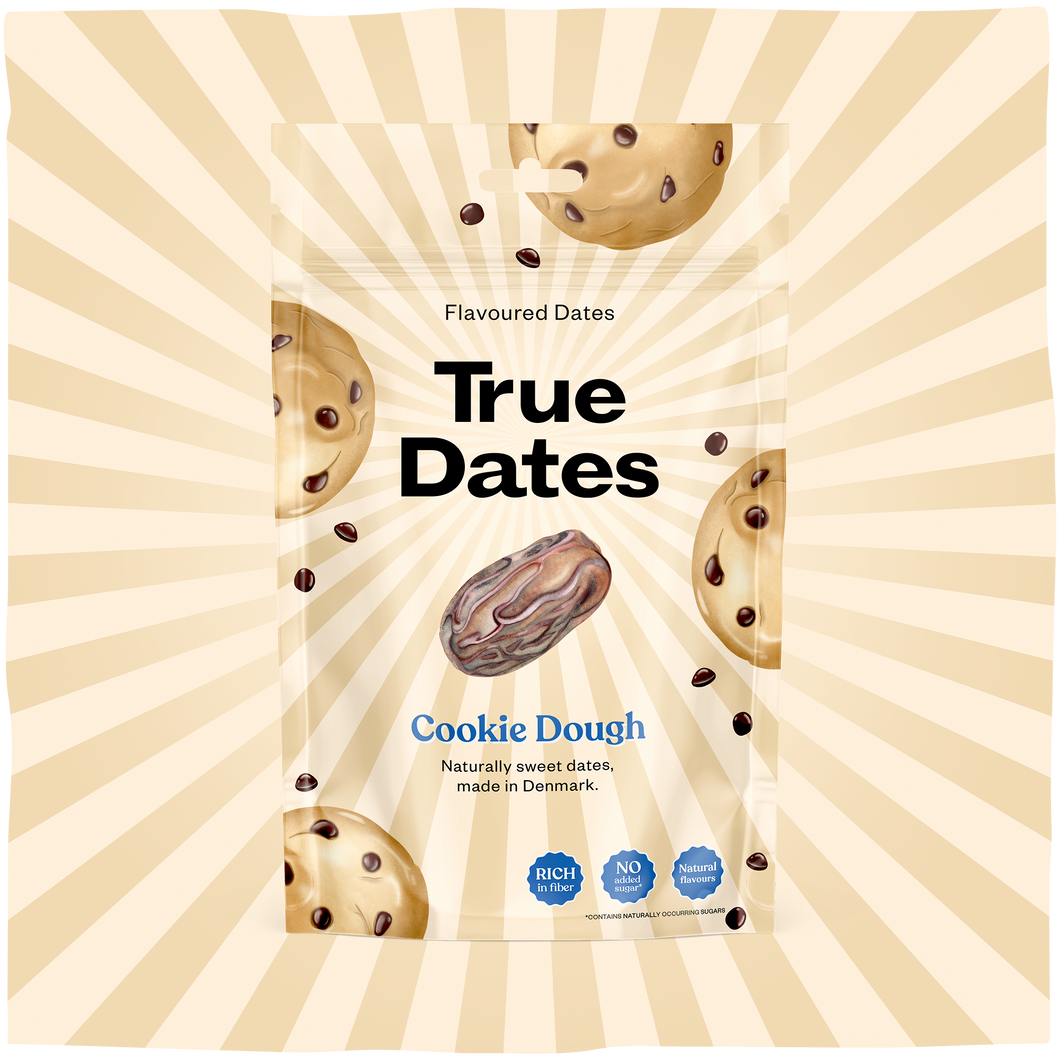 A cream-and-gold sunburst frames a True Dates flavoured dates pouch, with a date fruit and cookie-dough pieces; the packaging feels playful and appetising.
