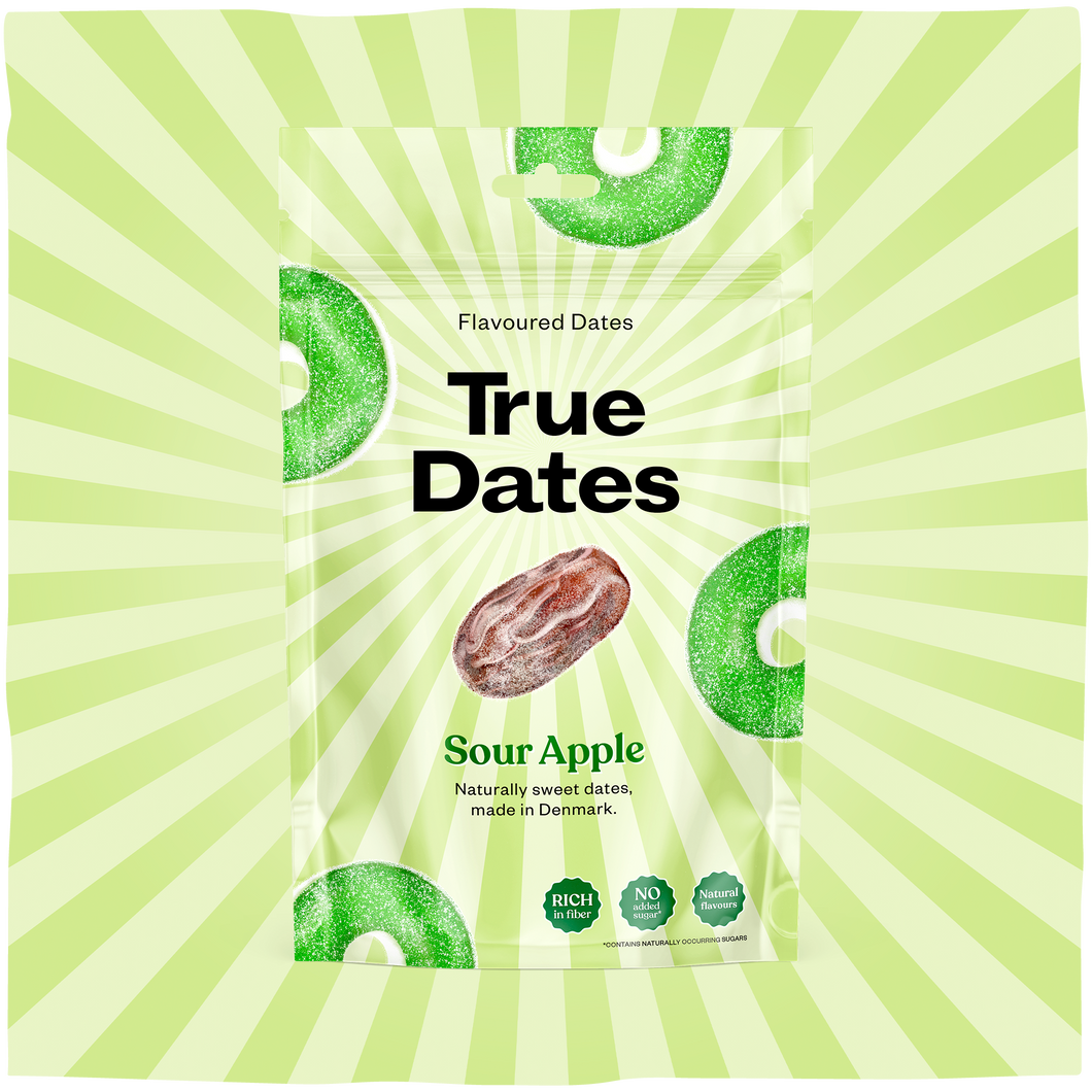 A green-and-white packet of True Dates sour apple-flavoured dates sits against a lime-green sunburst background, giving the snack packaging a bright, playful tone.